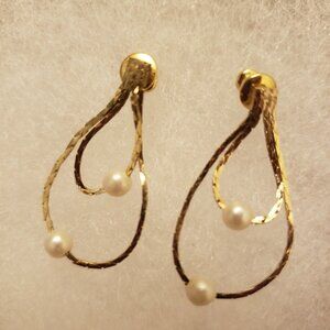 Yellow gold tone dangling loop earrings.